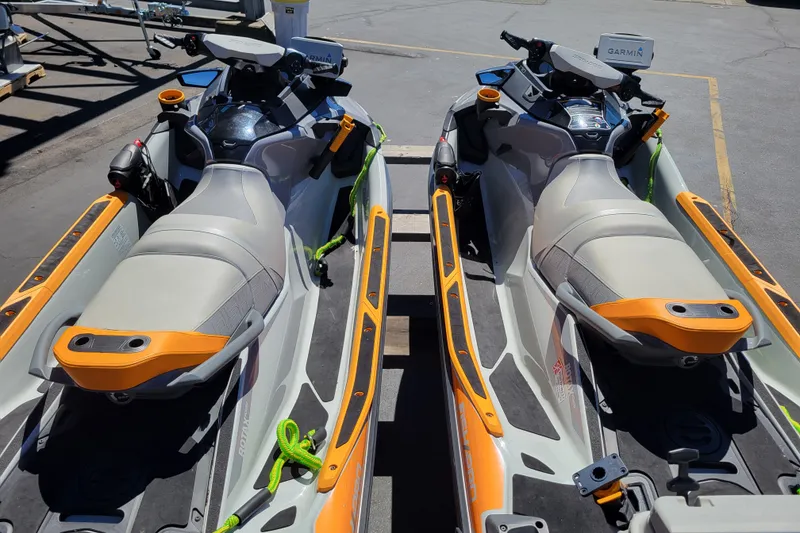 Slide: The Image of 2022 Sea-Doo FishPro Trophy 170 jet skis parked side by side on pavement. - 13