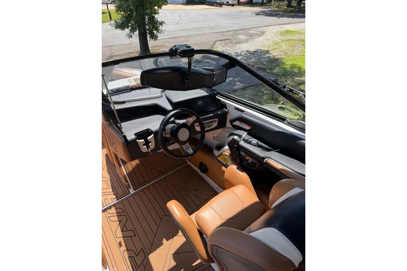 Slide: The Image of 2019 Nautique Super Air Nautique G25 boat interior with steering wheel and dashboard. - 19
