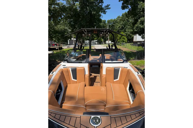 Slide: The Image of 2019 Nautique Super Air Nautique G25 boat with tan seating and sleek design. - 15