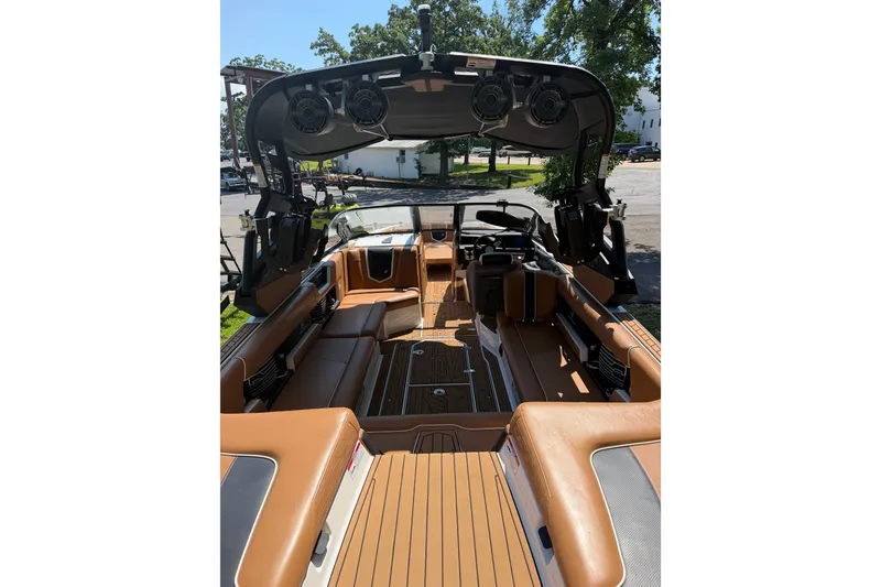 Slide: The Image of 2019 Nautique Super Air Nautique G25 interior with tan seating and advanced sound system. - 16