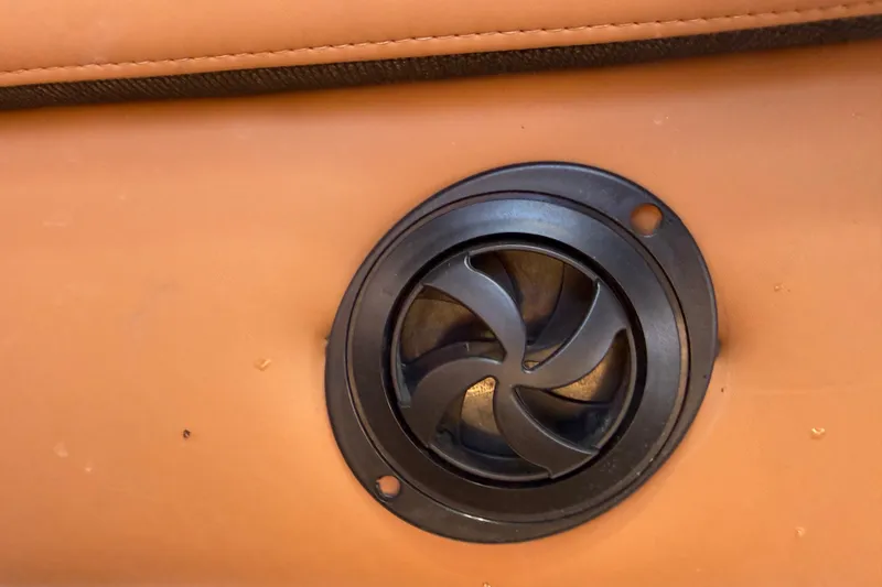 Slide: The Image of Close-up of a 2019 Nautique Super Air Nautique G25 speaker on tan upholstery. - 11