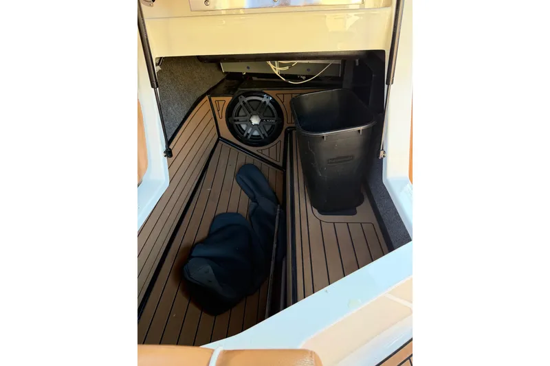Slide: The Image of 2019 Nautique Super Air Nautique G25 interior storage with speaker and bin. - 10