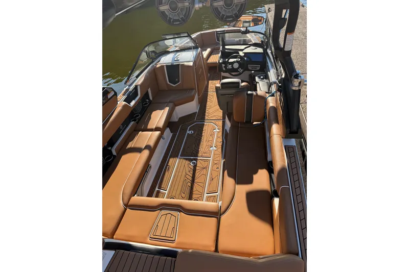 Slide: The Image of 2019 Nautique Super Air Nautique G25 interior with luxurious tan seating and sleek design. - 4