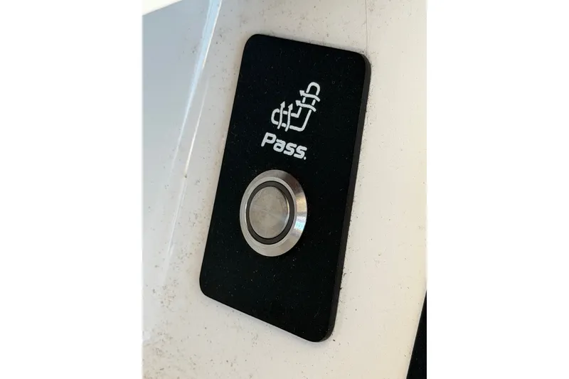 Slide: The Image of 2019 Nautique Super Air Nautique G25 control button labeled "Pass" on black panel. - 12