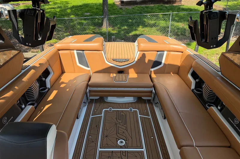 Slide: The Image of Luxurious interior of 2019 Nautique Super Air Nautique G25 boat with tan seating. - 20