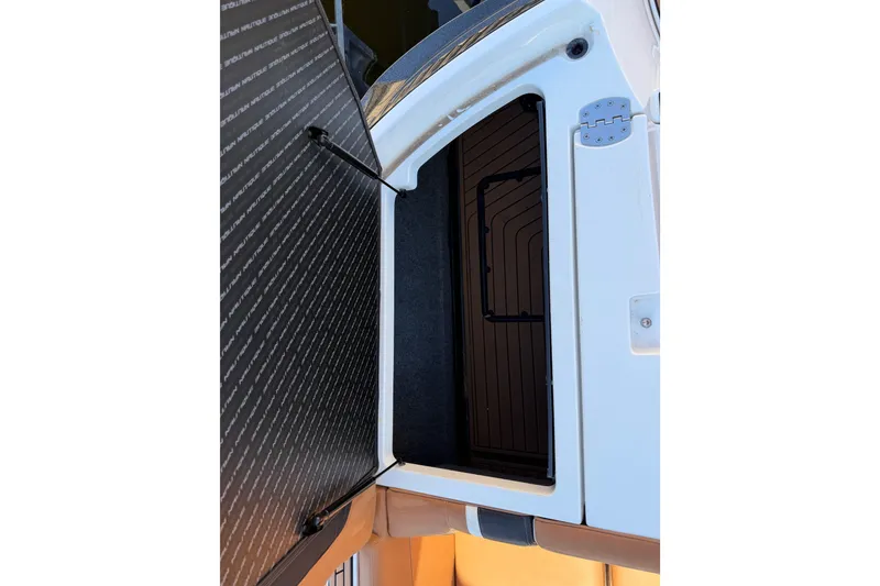 Slide: The Image of 2019 Nautique Super Air Nautique G25 storage compartment with open hatch. - 9
