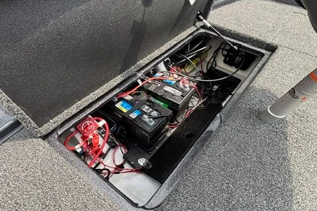 Slide: The Image of Open battery compartment of 2025 Nitro Z20 XL boat, showing wiring and connections. - 32