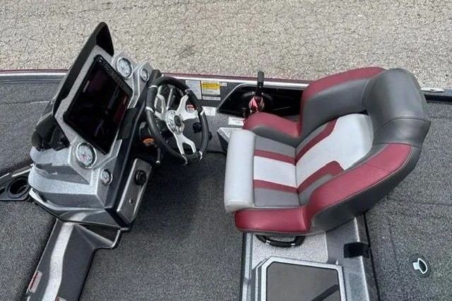 Slide: The Image of 2025 Nitro Z20 XL boat cockpit with steering wheel and cushioned seat. - 16