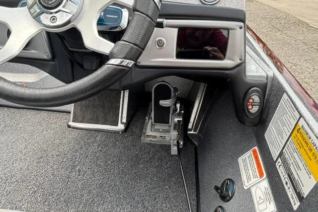 Slide: The Image of Interior view of a 2025 Nitro Z20 XL boat cockpit with steering wheel and controls. - 19