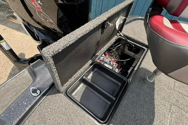 Slide: The Image of Open storage compartment in a 2025 Nitro Z20 XL boat, revealing wiring and battery setup. - 31
