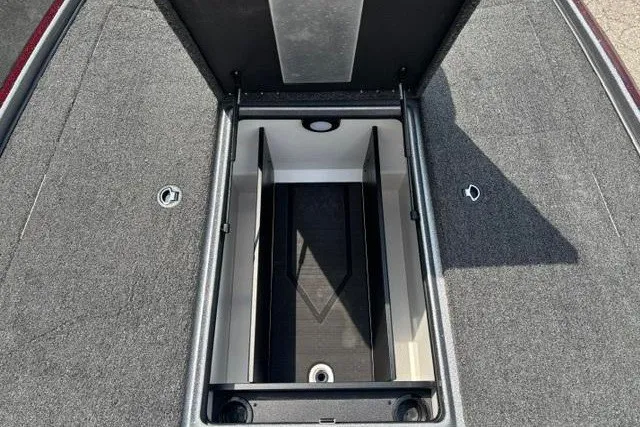 Slide: The Image of Open storage compartment in 2025 Nitro Z20 XL boat, featuring carpeted interior and organized layout. - 13