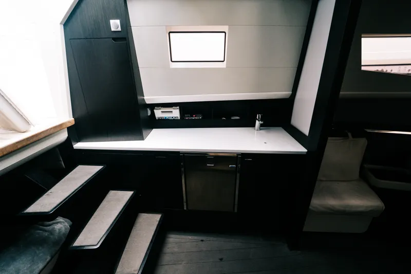 Slide: The Image of Interior of 2022 Windy SR44 yacht featuring modern kitchenette and seating area. - 23