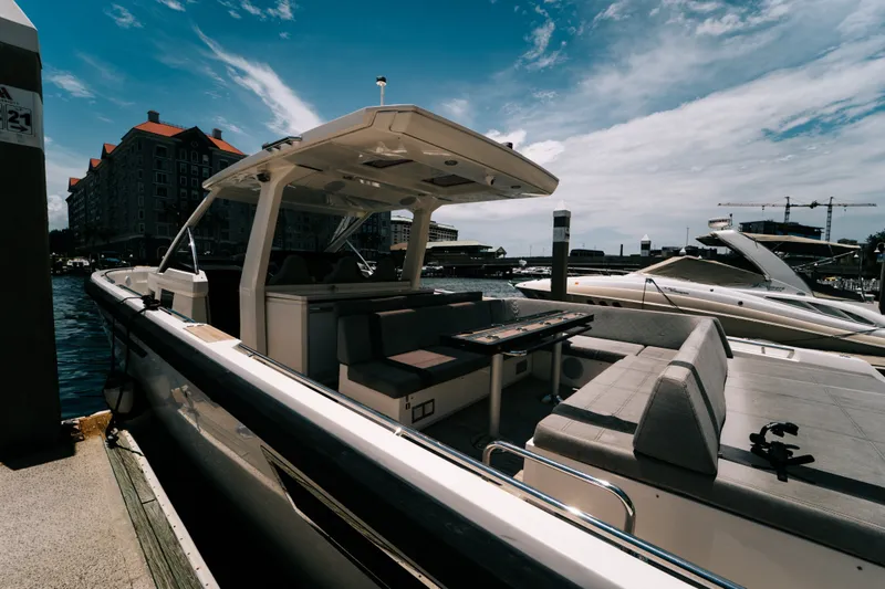 Slide: The Image of 2022 Windy SR44 luxury yacht docked at marina under blue sky. - 2