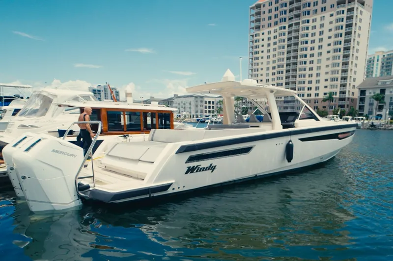 Slide: The Image of A modern Windy SR44 yacht from 2022 is docked in the water with an urban backdrop. - 3