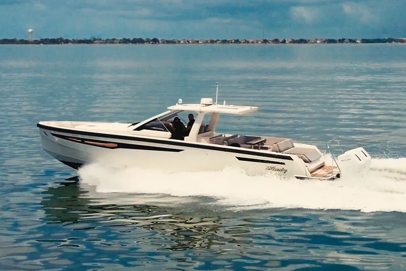 The Image of A sleek motorboat cruising over calm waters. It features a modern design and open cabin. - 1