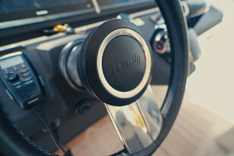 Slide: The Image of Steering wheel of 2022 Windy SR44 boat, featuring sleek design and modern controls. - 15