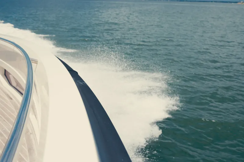 Slide: The Image of 2022 Windy SR44 yacht cruising on open water, creating a dynamic wake. - 8