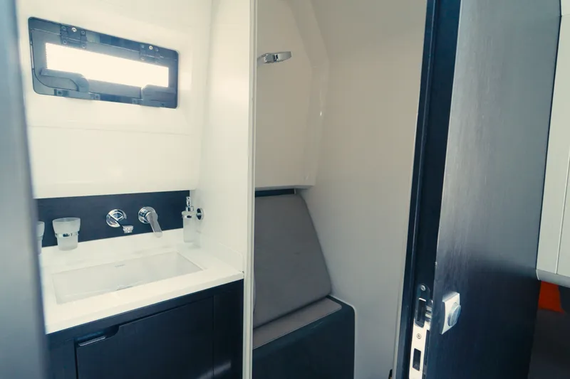Slide: The Image of Modern bathroom interior of 2022 Windy SR44 yacht, featuring sleek sink and window. - 19