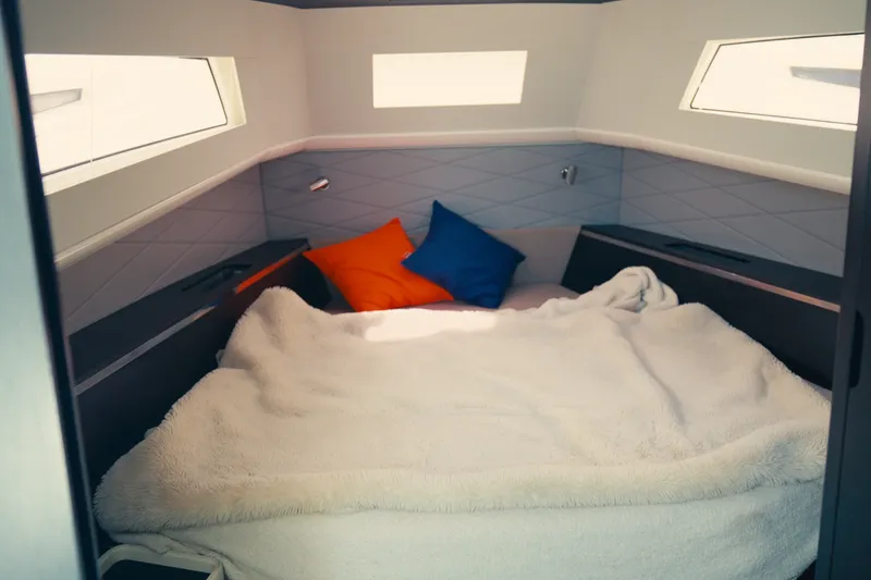 Slide: The Image of Cozy cabin interior of 2022 Windy SR44 yacht with plush bedding and colorful pillows. - 24