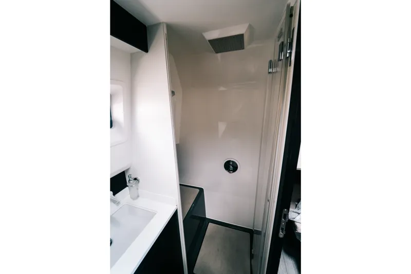 Slide: The Image of Modern bathroom interior of 2022 Windy SR44 yacht, featuring sleek shower and sink design. - 22