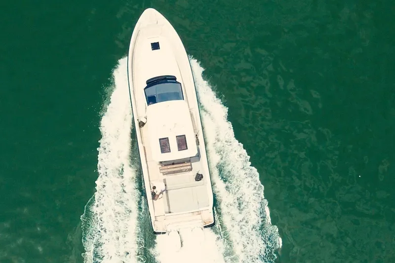 Slide: The Image of A sleek, modern boat cruises through green water, leaving a trail of white wake. - 9