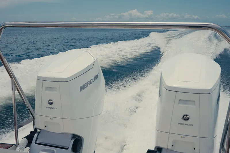 Slide: The Image of Twin Mercury Verado engines powering a 2022 Windy SR44 boat on open water. - 6