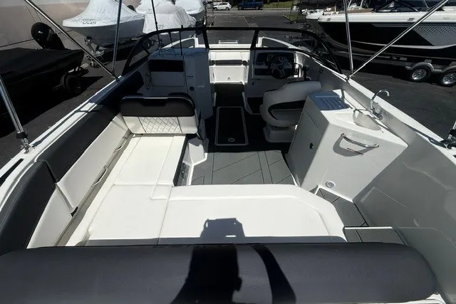 Slide: The Image of 2026 Bayliner D22 boat interior with seating, steering wheel, and sink. - 17