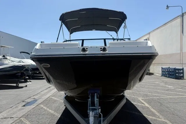 Slide: The Image of 2026 Bayliner D22 boat with canopy, parked on a trailer in a lot. - 20
