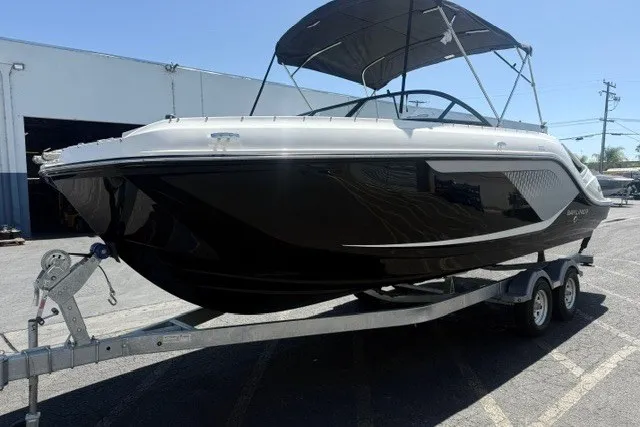 Slide: The Image of 2026 Bayliner D22 boat on trailer, black and white design, parked outdoors. - 23