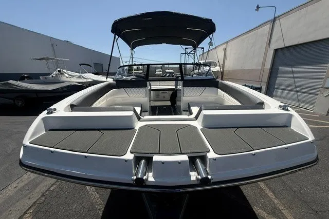 Slide: The Image of 2026 Bayliner D22 boat with spacious seating and canopy in a marina setting. - 19