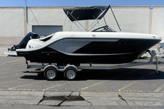 Slide: The Image of 2026 Bayliner D22 boat on trailer, black and white design, parked outdoors. - 24