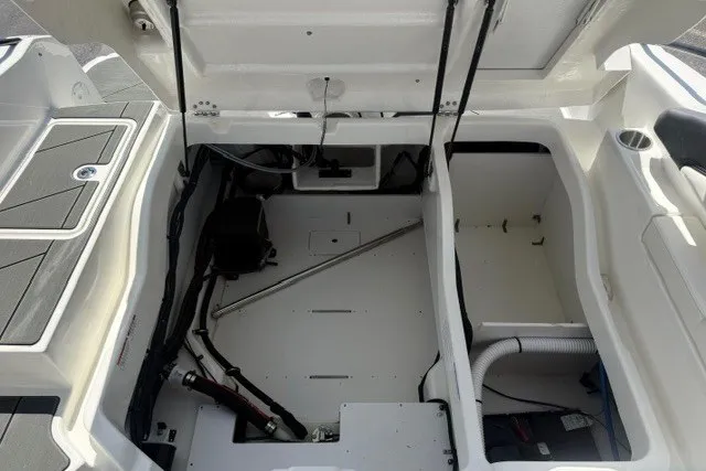 Slide: The Image of 2026 Bayliner D22 boat interior showing open storage compartments and mechanical components. - 15