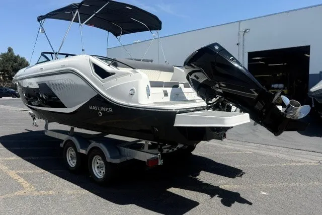 Slide: The Image of 2026 Bayliner D22 boat on trailer, featuring sleek design and powerful outboard motor. - 21