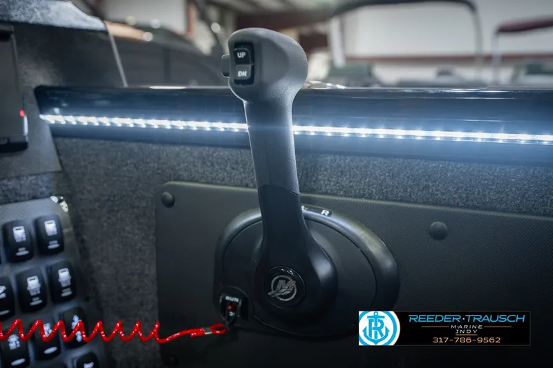 Slide: The Image of Control panel of 2026 Lund 1975 Pro-V Sport boat with illuminated switches and throttle. - 47