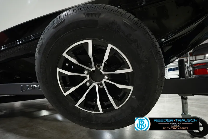 Slide: The Image of Close-up of a 2026 Lund 1975 Pro-V Sport trailer wheel in a showroom. - 66