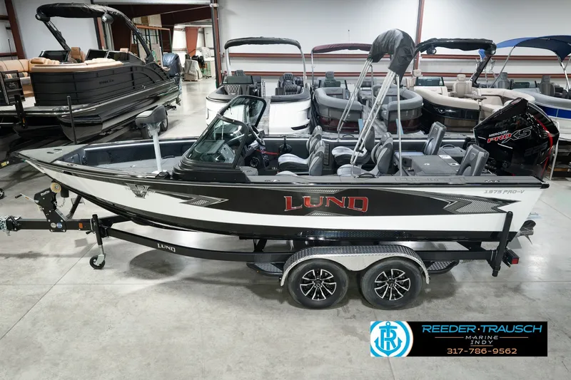 The Image of 2026 Lund 1975 Pro-V Sport boat in showroom, featuring sleek design and modern amenities. - 0
