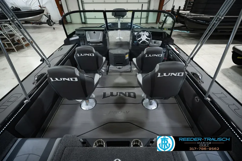 Slide: The Image of Interior of 2026 Lund 1975 Pro-V Sport boat with four seats and steering console. - 18