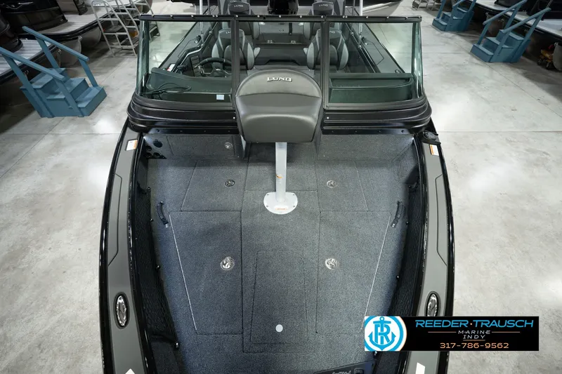 Slide: The Image of 2026 Lund 1975 Pro-V Sport boat interior with seating and carpeted deck. - 22