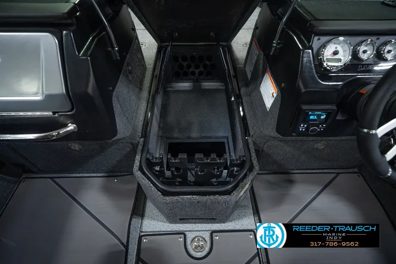 Slide: The Image of Interior view of 2026 Lund 1975 Pro-V Sport boat, featuring dashboard and storage compartment. - 33
