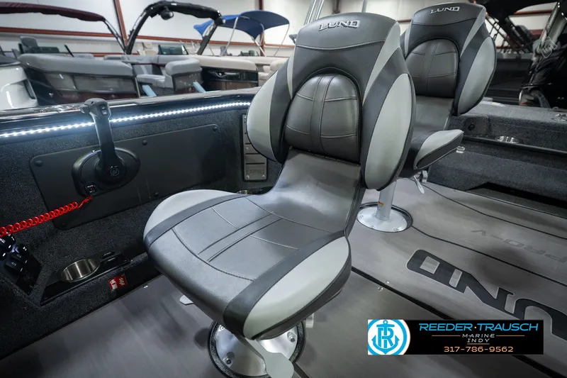Slide: The Image of 2026 Lund 1975 Pro-V Sport boat interior with sleek seating and modern controls. - 48