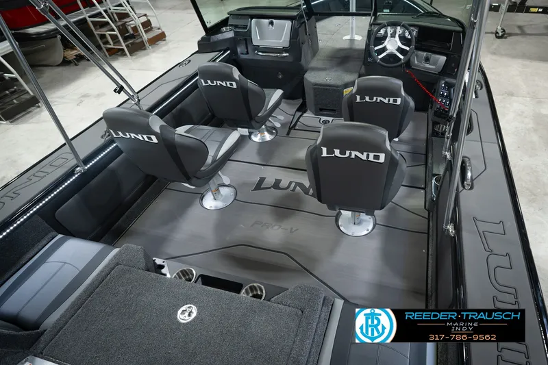 Slide: The Image of 2026 Lund 1975 Pro-V Sport boat interior with four seats and steering console. - 16