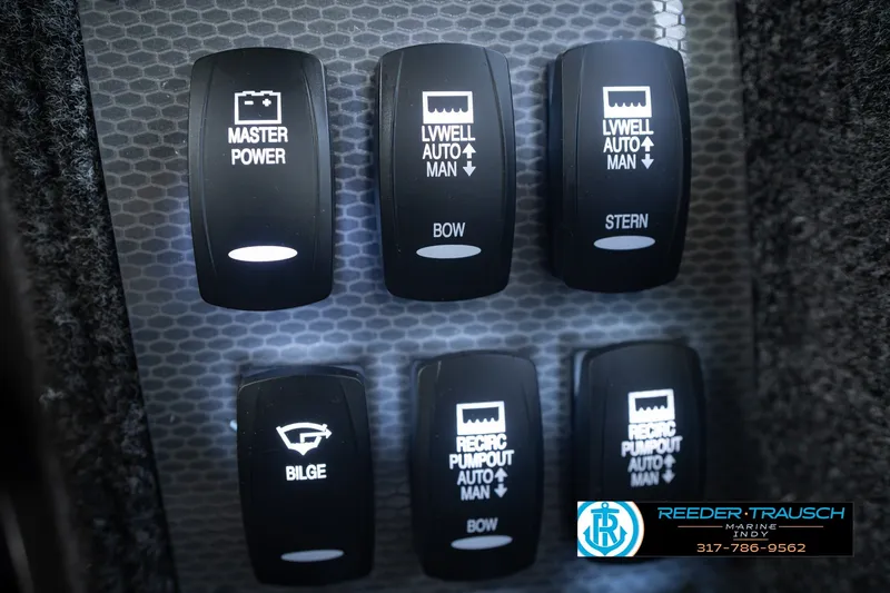 Slide: The Image of Control panel switches on a 2026 Lund 1975 Pro-V Sport boat. - 45