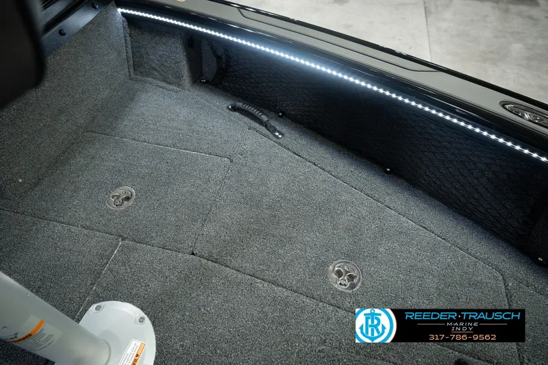 Slide: The Image of Interior of 2026 Lund 1975 Pro-V Sport boat with carpeted flooring and LED lighting. - 34