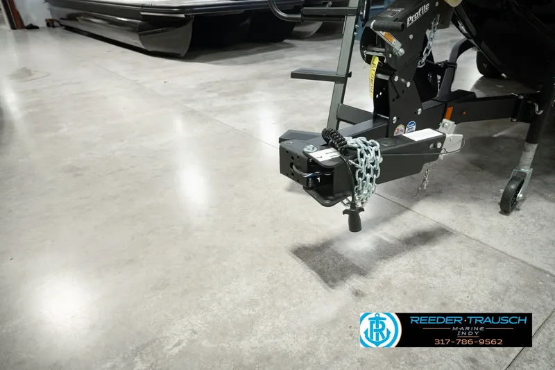 Slide: The Image of Trailer hitch of a 2026 Lund 1975 Pro-V Sport boat in a showroom. - 65