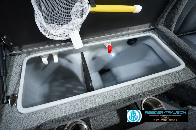 Slide: The Image of Livewell compartment in 2026 Lund 1975 Pro-V Sport boat, featuring net and plumbing. - 55