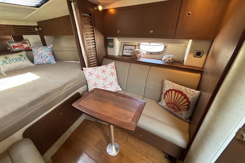 Slide: The Image of Interior of 2013 Sea Ray Sundancer 310 with cozy seating and decorative pillows. - 29