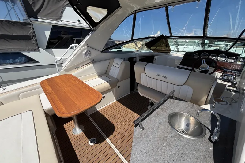 Slide: The Image of Interior of 2013 Sea Ray Sundancer 310 yacht with seating, table, and helm. - 11