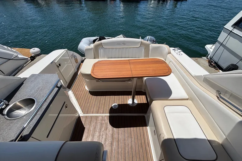 Slide: The Image of Luxurious 2013 Sea Ray Sundancer 310 yacht interior with seating and wooden table. - 10
