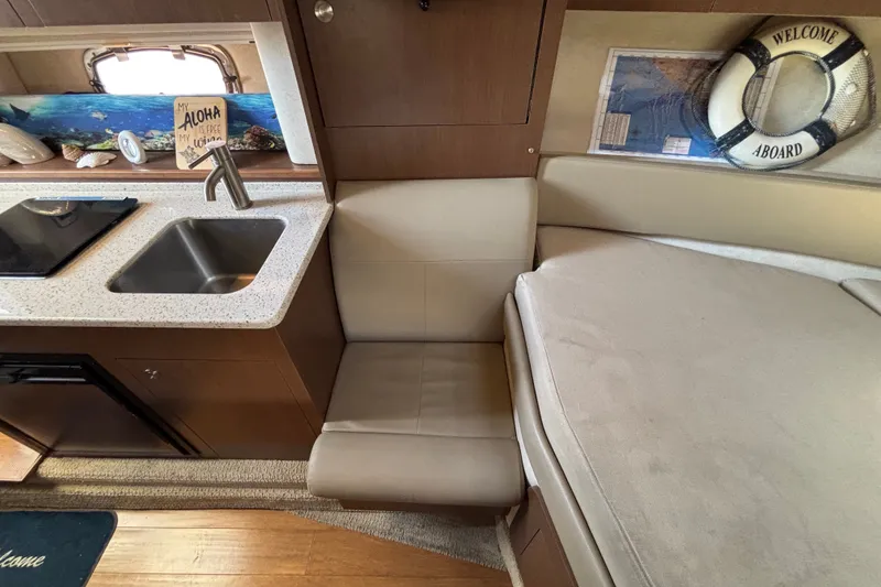 Slide: The Image of Interior of 2013 Sea Ray Sundancer 310 with kitchenette and seating area. - 28
