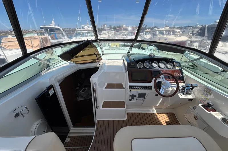 Slide: The Image of Cockpit view of 2013 Sea Ray Sundancer 310 yacht, featuring helm controls and dashboard. - 12